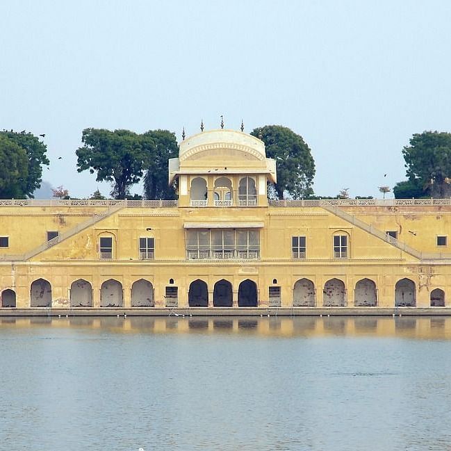 Jal Mahal facade, reflecting beautifully on the water, set against the sky.